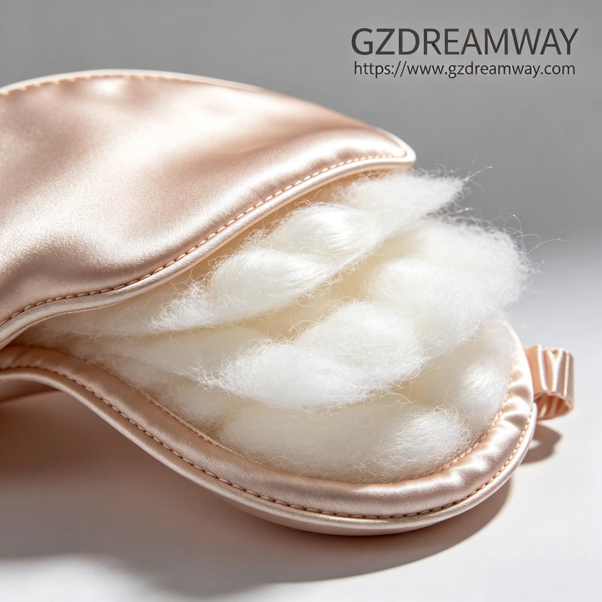 Exploded view macro shot of luxury silk eye mask showing 3-layer structure with outer silk outer and fluffy silk filling
