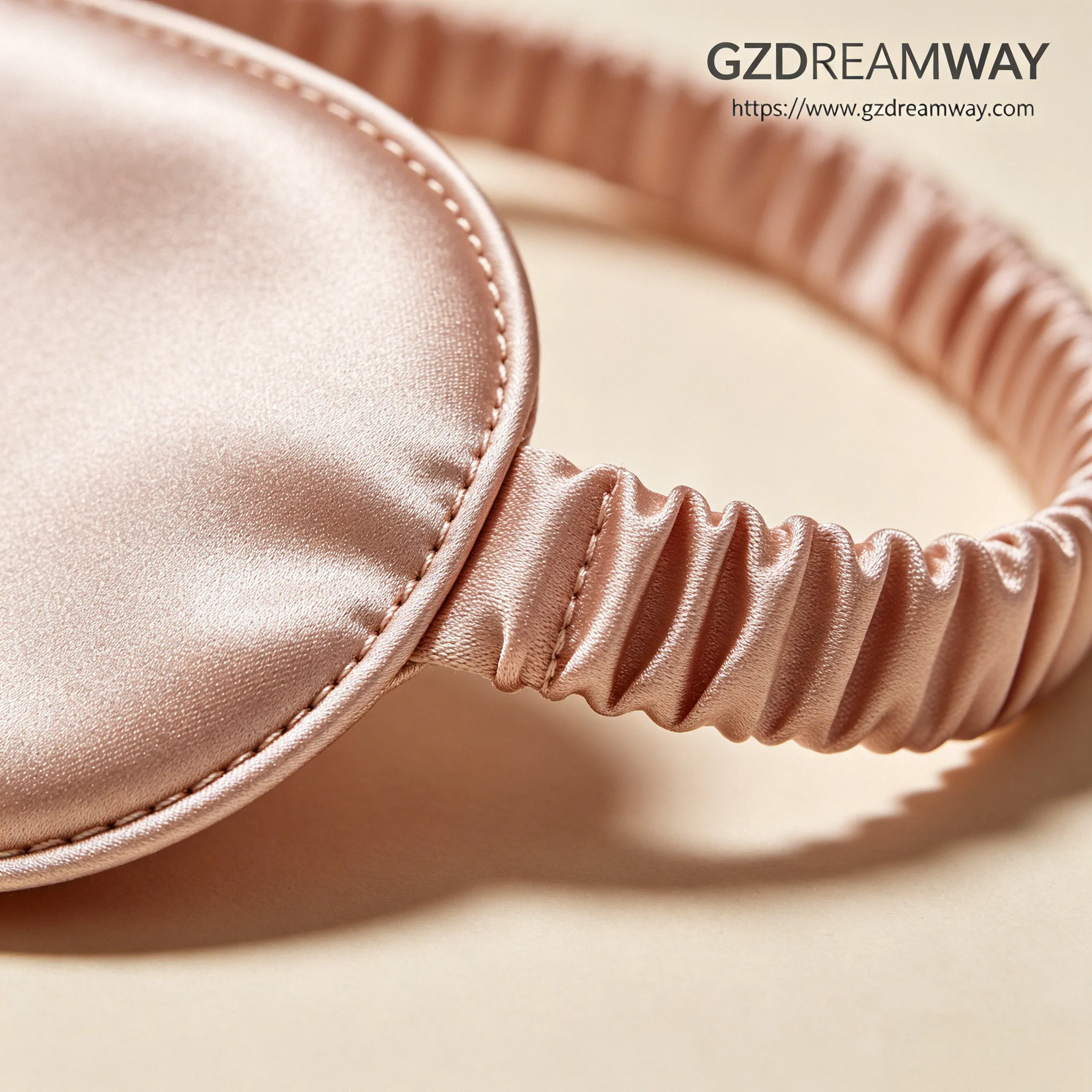 Extreme macro photography of luxury silk eye mask elastic band connection showing flawless straight stitching