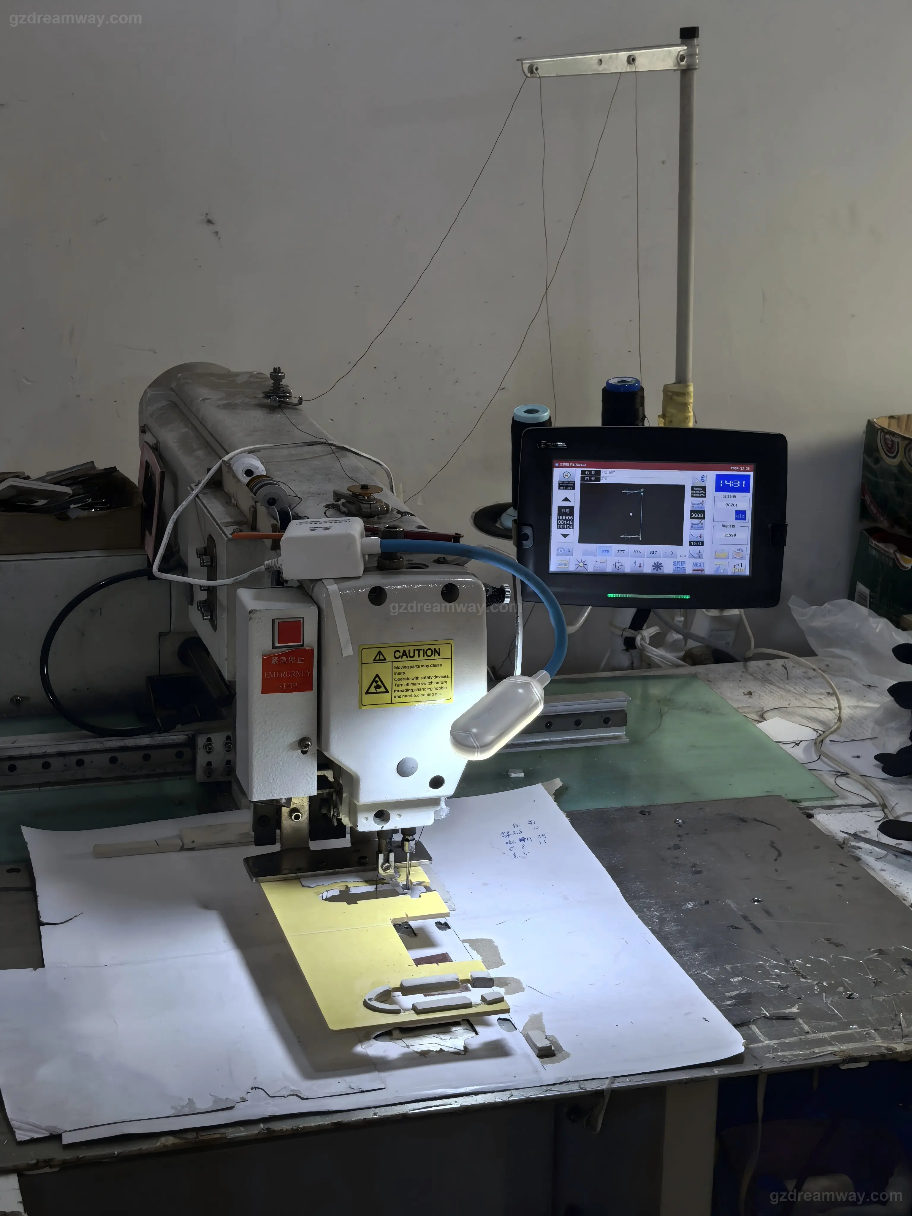 Computerized template sewing machine (ZHONGBA 3020 with DAHAO control system) stitching identical stitch lines on a custom logo panel of leather bag, canvas tote bag and private-label wallet production inside GZ Dreamway Guangzhou factory